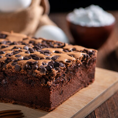 Chocolate flavor Taiwanese traditional sponge cake (Taiwanese castella kasutera) on a wooden tray background table with ingredients, close up.