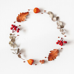 Autumn composition. Wreath made of dried flowers, eucalyptus leaves, berries on gray background....