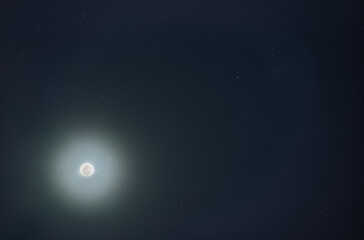 Fototapeta na wymiar Moon halo and stars