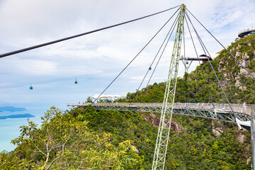 The sky bridge in the north of Langkawi, Malaysia. The landmark of the small Malaysian Island. One pillar and 12 cable holding the bridge over the valley. A  breathtaking view over the Andaman Sea 