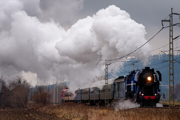 old steam locomotive in operation with wagons