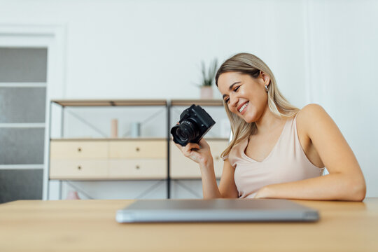 Portrait of a smiling girl looking at pictures on camera.