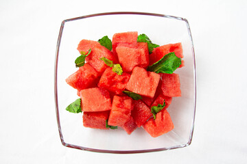 Watermelon cubes with mint close-up on white background