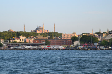 Fototapeta premium Hagia Sophia (Aya Sophia), Christian greek-orthodox patriarchal basilica, imperial mosque and museum, Istanbul, Turkey - view from Golden Horn to the Eminonu ferry quay. 