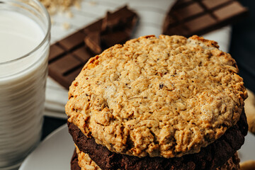 Chocolate and oat cookies on dark wooden table