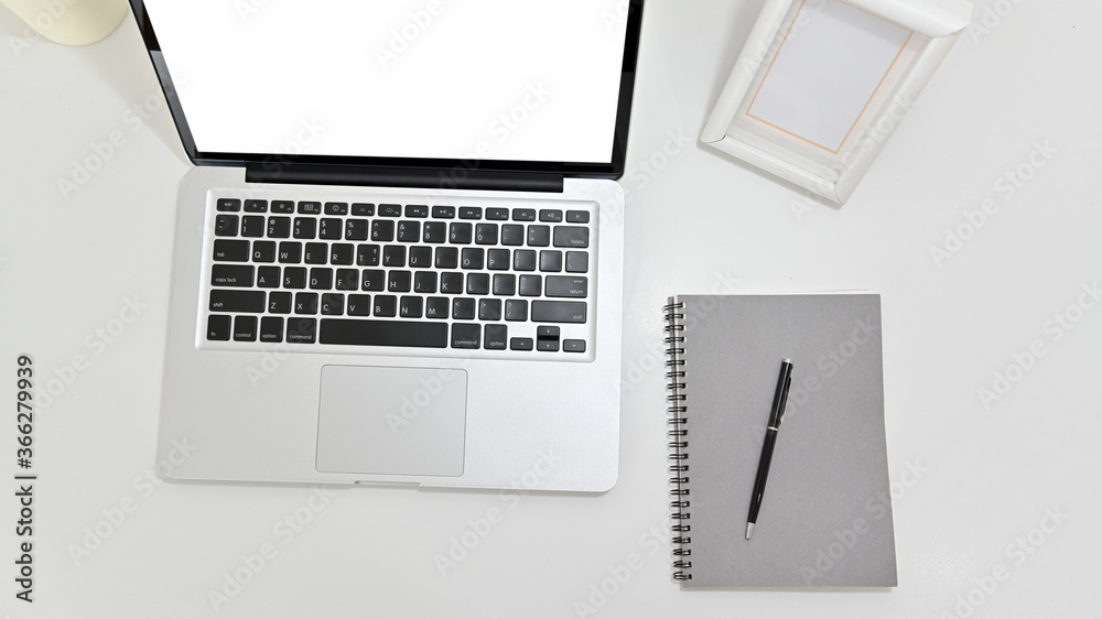 Wall mural Top view of modern workspace desk with laptop and notebook on white table. concept work from home.