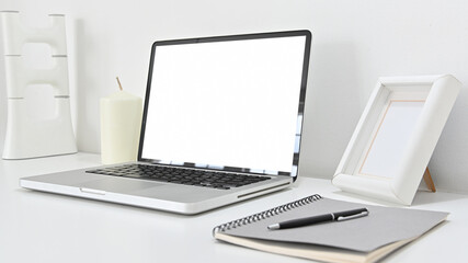 Fototapeta premium Modern decor of workspace with laptop and notebook on white background in home office.