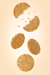 Falling oatmeal cookies isolated on a color background with clipping path. Flying food. Healthy eating. Front view