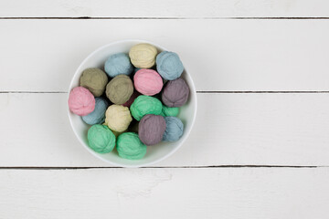 Colored nuts in a bowl on a white background
