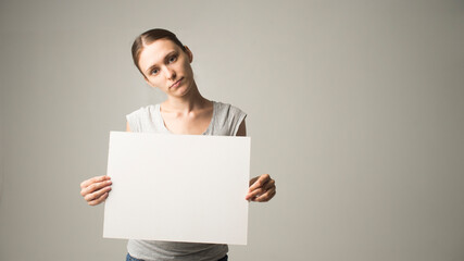 woman holding a sheet of paper in her hand