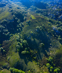Aerial view of the beech and karst. Sierra de Hornijo Mountain Range close by San Pedro de Soba village in Soba Valley, within Pasiegos Valleys and Alto Ason Natural Park of Cantabria in Spain. Europe