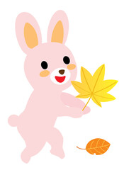 Fototapeta na wymiar 秋のモミジを持ったかわいいピンクのウサギ