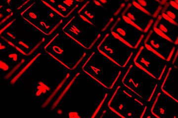 Close up view of a modern laptop computer keyboard key with red buttonss. Pc computer keyboard close up