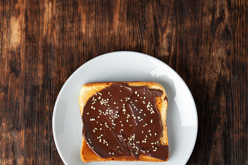 French toast covered with chocolate paste and sesame seeds