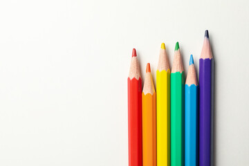 Colored pencils on white background, space for text