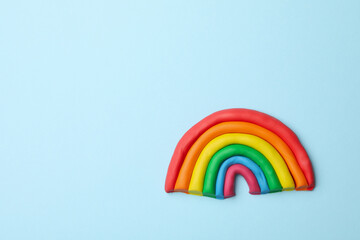 LGBT rainbow made of plasticine on blue background