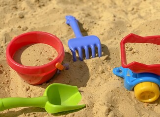 Fototapeta na wymiar Toys shovel, rake and bucket for children's sandbox. Children's toys.