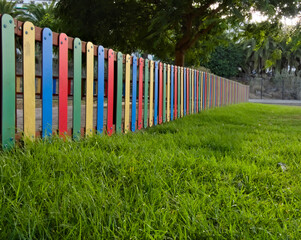 Sunset at a playground with colored fences