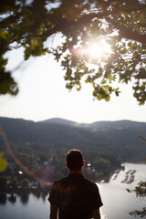 young man looking on beautiful view with sun sunflare