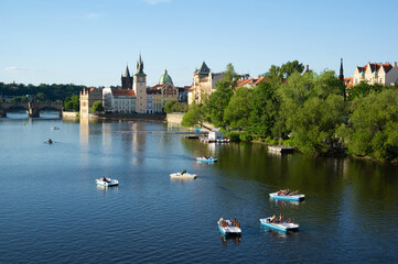 Vltava river, Prague, Czech Republic / Czechia - pedal boat on the river. Tourists and people are enjoying vacation, holiday and leisure time on the water during sunny summer evening.