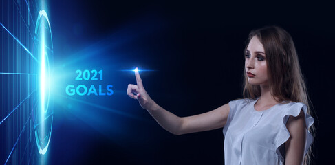 Business, Technology, Internet and network concept. Young businessman working on a virtual screen of the future and sees the inscription: 2021 goals