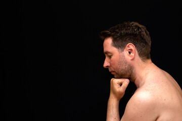 Fototapeta premium Side view sad thoughtful undressed handsome male demonstrating reverie.
