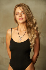 The adorable blonde girl wearing in black bodysuit