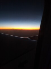 airplane landing at sunset