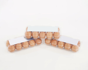 Eggs in plastic packaging with an isolated white background. Mock up the white sticker above for the logo space. These health premium eggs are commonly used for advertising or promo materials.