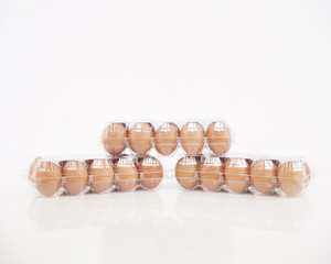 Eggs in plastic packaging with an isolated white background. Mock up the white sticker above for the logo space. These health premium eggs are commonly used for advertising or promo materials.