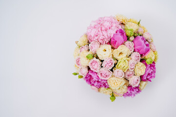 Beautiful colorful flowers bouquet on the white background. Bouquet made of peonies and different roses. Wedding flowers. Copy space for advert. View from above. Valentine's or Women's Day.