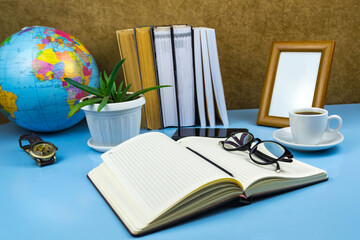 Fototapeta na wymiar Office workplace documents, glasses, coffee, notebook Blue background