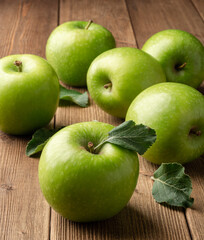 Fresh green apples on rustic wooden background