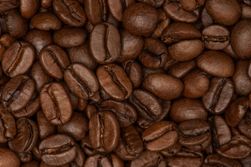 Fototapeta premium Coffee beans background. Fresh roasted coffee beans close up.