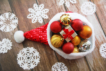 Santa Claus red hat and colorful toys balls on the a Christmas tree
