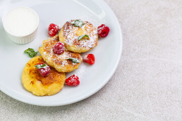 Cottage cheese pancakes with sour cream and raspberries