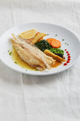 Fish dish, fried fish fillet and vegetables