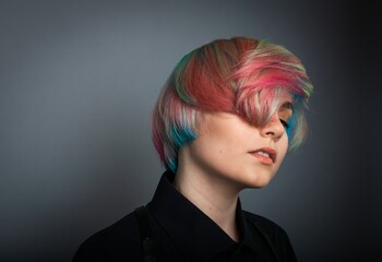 Portrait of nice rainbow color styling young girl with model hair on grey background