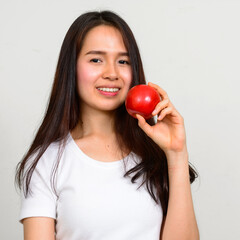 Portrait of happy young beautiful Asian woman