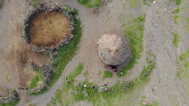 Aerial Flyby View on the Maasai village in front of the Ol Doinyo Lengai, Mountain of God in the Maasai language, Engare Sero village in Arusha Region i the Northern Tanzania, Africa, at Sunset time.