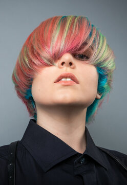 Portrait of nice rainbow color styling young girl with model hair on grey background
