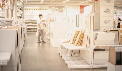 The unspecific man looking the many type of photo wood frame for collect the recognize photo memories.