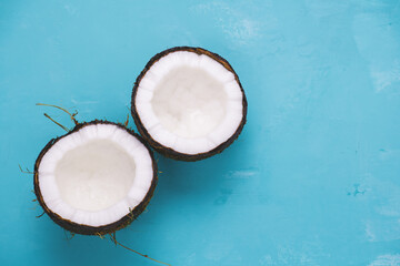 top view layout of fresh coconuts on a blue background