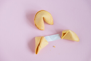 fortune cookie with blank white paper mock up on a pastel pink background copy space