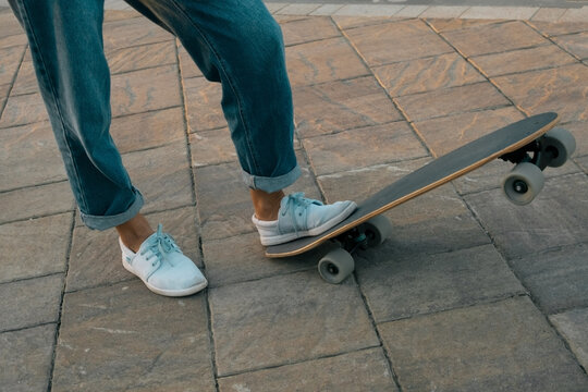 close up female legs with skateboard
