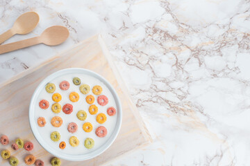 bowl of fruity cereal on a marble background top view flat lay