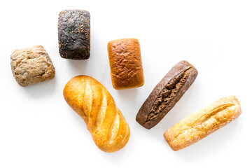Bakery. Fresh bread in assortment on white table top-down