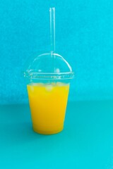 glass of orange juice on a blue background