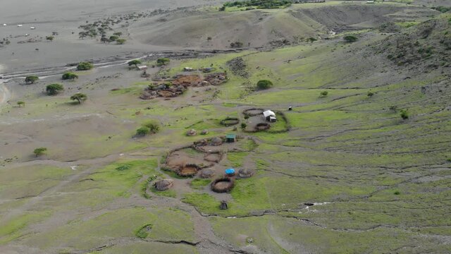 Aerial Flyby View on the Maasai village in front of the Ol Doinyo Lengai, Mountain of God in the Maasai language, Engare Sero village in Arusha Region i the Northern Tanzania, Africa, at Sunset time.