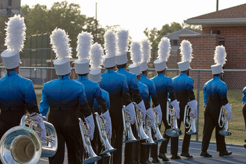 Young People marching in a band with trumpets and other instruments. 